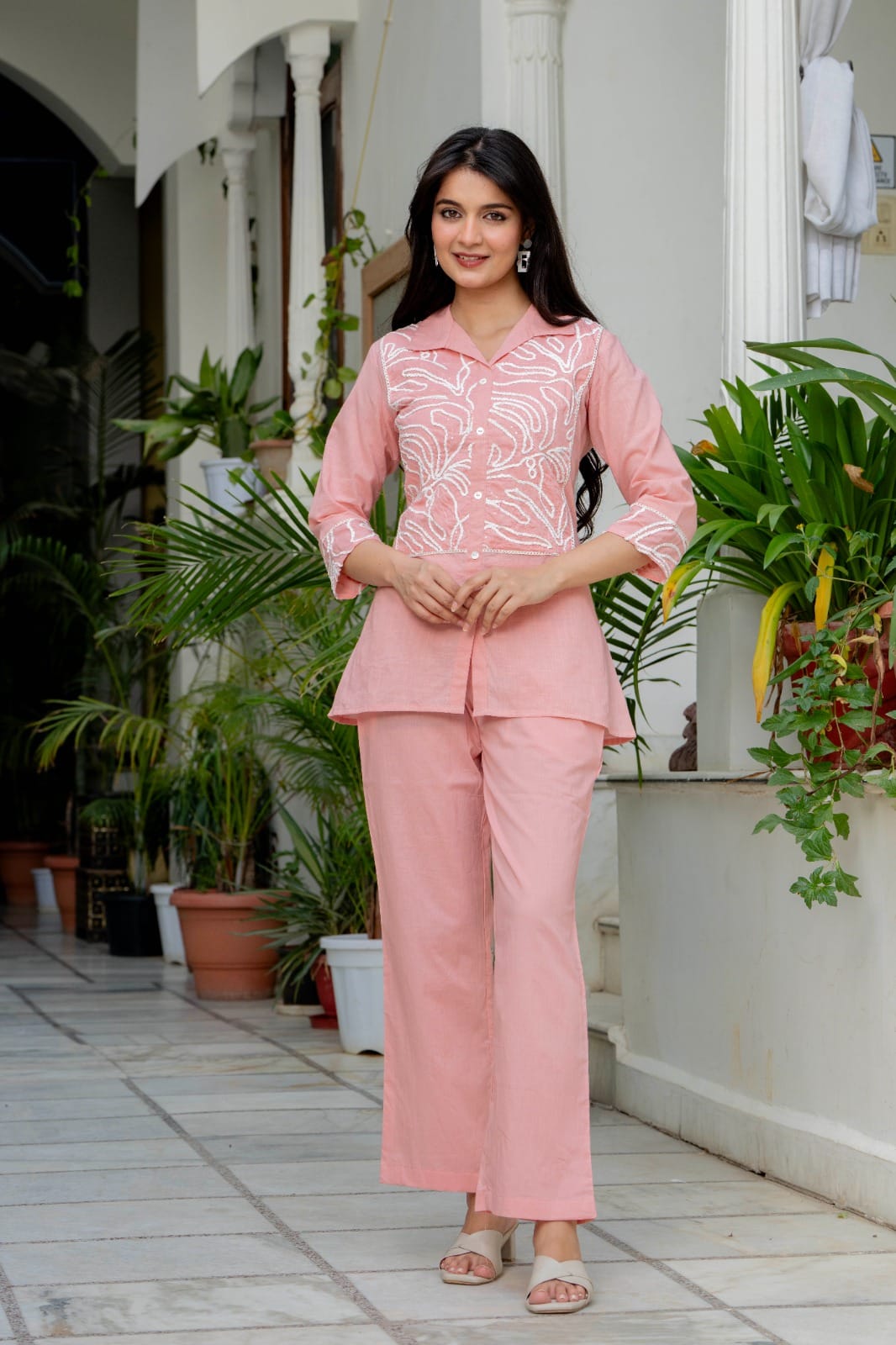 Front-button embroidered tunic shirt paired with full-length straight trousers for women.