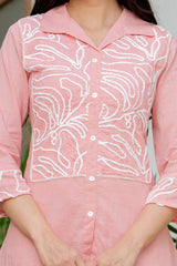 Smart casual and office wear two-piece cotton set with buttoned top and comfortable straight pants.