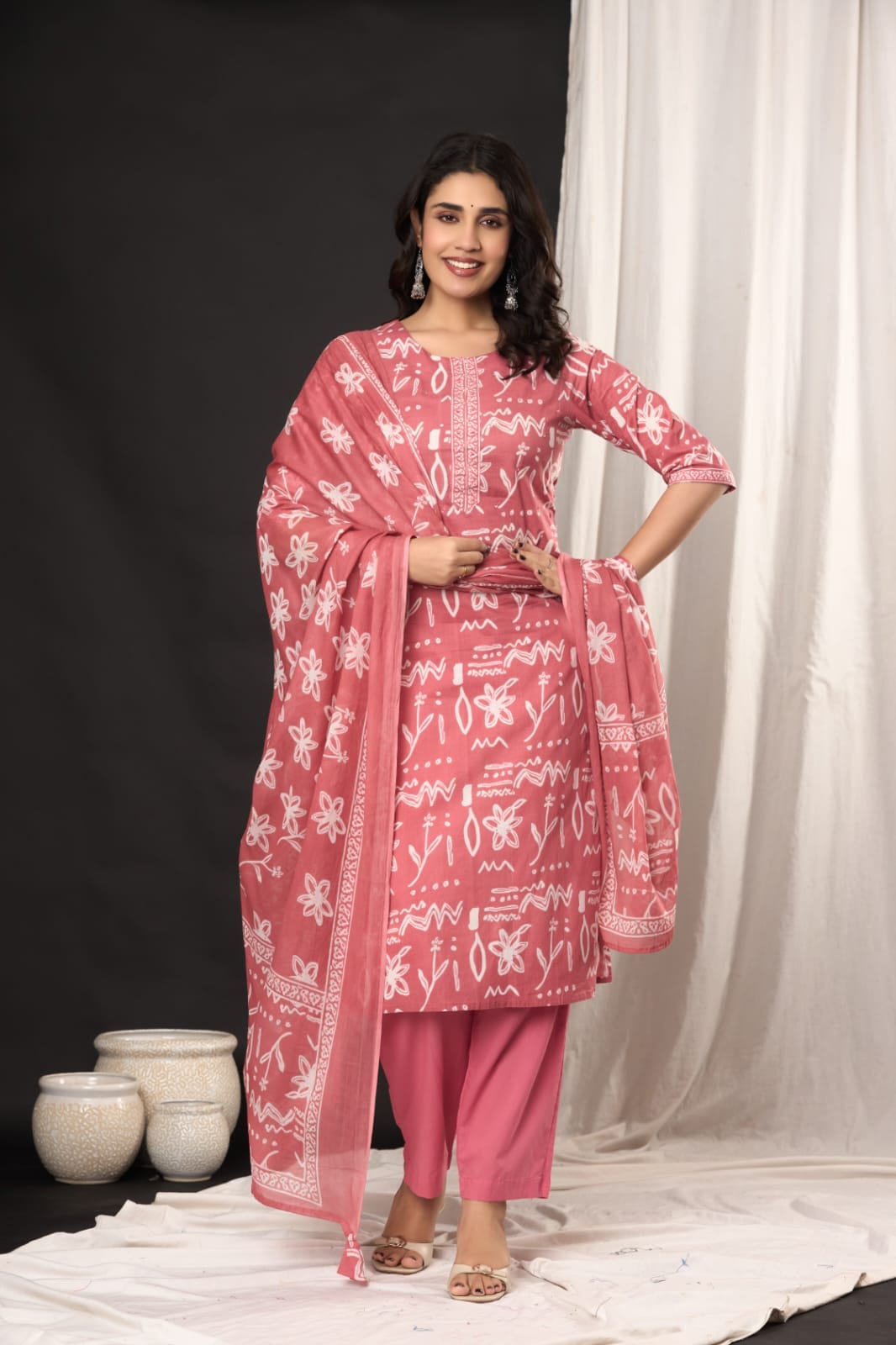 "Beautiful pink cotton suit with white block print design." (Highlights the color, material, and print style.)
