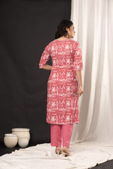 "Smiling woman posing in a pink and white traditional outfit." (Includes the model's action and general color theme.)
